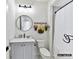 Clean bathroom features a sink, toilet, shower with decorative curtain and floral decorations at 19419 Youngblood W Rd # 2, Charlotte, NC 28278