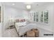 Charming bedroom featuring a luxurious bed, decorative side tables and natural light from large windows at 19419 Youngblood W Rd # 2, Charlotte, NC 28278