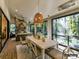 Inviting outdoor dining area with fireplace, ceiling fan, and forest views, perfect for entertaining at 19419 Youngblood W Rd # 2, Charlotte, NC 28278