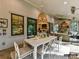 Inviting outdoor dining area with fireplace, ceiling fan, and forest views, perfect for entertaining at 19419 Youngblood W Rd # 2, Charlotte, NC 28278