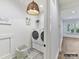 Convenient laundry room with modern washer and dryer, stylish lighting, and plenty of storage space at 19419 Youngblood W Rd # 2, Charlotte, NC 28278
