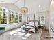 Bright main bedroom features natural light, a four-poster bed, and serene views of the surrounding trees at 19419 Youngblood W Rd # 2, Charlotte, NC 28278