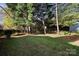 Spacious backyard with mature trees and lush grass, offering a private and serene outdoor space at 19933 Scanmar Ln, Cornelius, NC 28031