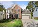 Beautiful two-story home with brick and siding, offering a well-manicured lawn and attached two-car garage at 19933 Scanmar Ln, Cornelius, NC 28031