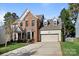 Charming two-story brick home featuring a two-car garage, bay window, and well-maintained landscaping at 19933 Scanmar Ln, Cornelius, NC 28031