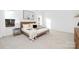 Spacious bedroom with neutral tones, large windows, and a cozy, comfortable bed at 25966 Appleyard Ct # 1205, Lancaster, SC 29720