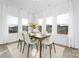 Elegant dining area with natural light, sleek floors, and a modern table setting at 25966 Appleyard Ct # 1205, Lancaster, SC 29720