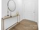 Bright entryway with a stylish console table, decorative mirror, and hardwood flooring at 25966 Appleyard Ct # 1205, Lancaster, SC 29720