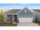 Charming single-Gathering home boasting blue siding, brick accents, and a two-car garage at 25966 Appleyard Ct # 1205, Lancaster, SC 29720