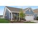 Charming single-Gathering home boasting blue siding, brick accents, and a two-car garage at 25966 Appleyard Ct # 1205, Lancaster, SC 29720