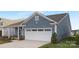 View of two-car garage and concrete driveway of charming single-Gathering home at 25966 Appleyard Ct # 1205, Lancaster, SC 29720