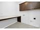 Well-lit laundry room with gray floors, custom counter, and storage cabinets at 25966 Appleyard Ct # 1205, Lancaster, SC 29720
