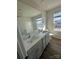 Modern bathroom with double vanity, granite countertops, and window providing natural light at 2616 Tillman St, Monroe, NC 28112