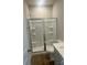 Bathroom featuring glass shower doors, single sink, and wood look floors at 2616 Tillman St, Monroe, NC 28112