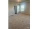 Spacious bedroom with plush carpeting and natural light from the window at 2616 Tillman St, Monroe, NC 28112