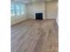 Spacious living room with fireplace, hardwood floors, and ample windows at 2616 Tillman St, Monroe, NC 28112