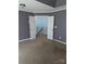 A spacious bedroom with neutral carpet and gray walls leading to the staircase at 279 Age Old Way, Rock Hill, SC 29732