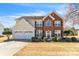 Charming two-story home with a brick facade, well-manicured landscaping, and a two-car garage at 279 Age Old Way, Rock Hill, SC 29732