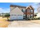 Attractive home featuring a brick and vinyl facade, double garage, and a well-kept front lawn at 279 Age Old Way, Rock Hill, SC 29732