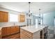 Bright kitchen features wooden cabinets, white countertops, backsplash and stainless steel appliances at 279 Age Old Way, Rock Hill, SC 29732