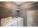 Laundry room with a washer, dryer, and shelving, providing ample storage space at 279 Age Old Way, Rock Hill, SC 29732