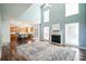 Bright living room features a high ceiling, fireplace, and seamless flow into the kitchen at 279 Age Old Way, Rock Hill, SC 29732