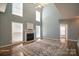 Open-concept living room with a soaring ceiling, large windows, and cozy fireplace at 279 Age Old Way, Rock Hill, SC 29732