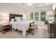 Bright bedroom featuring a tray ceiling, large windows, and a neutral color palette at 2941 Bellasera Way, Matthews, NC 28105
