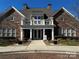 Elegant stone clubhouse with inviting entrance, a welcoming community gathering space at 2941 Bellasera Way, Matthews, NC 28105