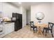 Bright kitchen showcases white cabinets, granite countertops, black appliances, and a charming breakfast nook at 2941 Bellasera Way, Matthews, NC 28105