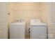 Functional laundry area equipped with a washing machine, dryer, and storage shelf at 2941 Bellasera Way, Matthews, NC 28105