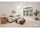 Comfortable living area with sectional sofa, large window, and vaulted ceiling, perfect for relaxing at 2941 Bellasera Way, Matthews, NC 28105