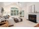 Inviting living room features a fireplace, large window, and plush seating, creating a cozy atmosphere at 2941 Bellasera Way, Matthews, NC 28105