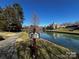 Scenic pond with a 'Private Property' sign, offering a serene fishing spot for residents at 2941 Bellasera Way, Matthews, NC 28105