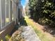 Well-maintained side yard with a concrete walkway and lush greenery at 2941 Bellasera Way, Matthews, NC 28105