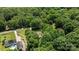 Aerial view showcasing the property's lush greenery, long driveway, and serene wooded surroundings at 3039 Paraham S Rd, York, SC 29745