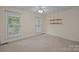This bedroom features two windows providing natural light and hanging shelves for storage at 3039 Paraham S Rd, York, SC 29745