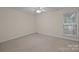 This bedroom features neutral walls, carpet, and a ceiling fan and a window for natural light at 3039 Paraham S Rd, York, SC 29745