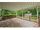 Relaxing covered deck with wood railings, offering a private outdoor space surrounded by lush greenery and a storage shed at 3039 Paraham S Rd, York, SC 29745