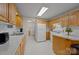 Bright kitchen features classic cabinets, white appliances, and an adjacent laundry room at 3039 Paraham S Rd, York, SC 29745