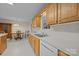 Kitchen and dining area with wood cabinets, white appliances, and an open layout for effortless cooking and dining at 3039 Paraham S Rd, York, SC 29745