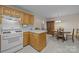 Open kitchen view showcasing wood cabinets, white appliances, and a seamless transition to the dining area for easy entertaining at 3039 Paraham S Rd, York, SC 29745