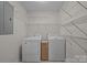 Organized laundry room with white shelving and appliances, providing a practical space for laundry needs at 3039 Paraham S Rd, York, SC 29745