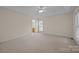 Spacious main bedroom with large windows, carpet, tray ceiling and a view into the Primary bath at 3039 Paraham S Rd, York, SC 29745