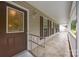 Covered front porch with a decorative glass door, multiple windows, and a ramp, providing an accessible and welcoming entrance at 3039 Paraham S Rd, York, SC 29745