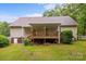 Backyard featuring a wooden deck with awning, stepping stones, and landscaped yard at 3039 Paraham S Rd, York, SC 29745
