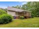 Backyard view of a wooden deck with awning and landscaped yard at 3039 Paraham S Rd, York, SC 29745