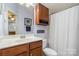 Bathroom vanity with wood cabinets, modern sink, and decor accents at 3439 Richards Xing, Fort Mill, SC 29708