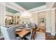 Dining room with wood table set for six, lovely light fixture, and view of kitchen at 3439 Richards Xing, Fort Mill, SC 29708