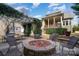 Charming backyard with a stone fire pit, seating, and a pergola, perfect for outdoor gatherings at 3439 Richards Xing, Fort Mill, SC 29708